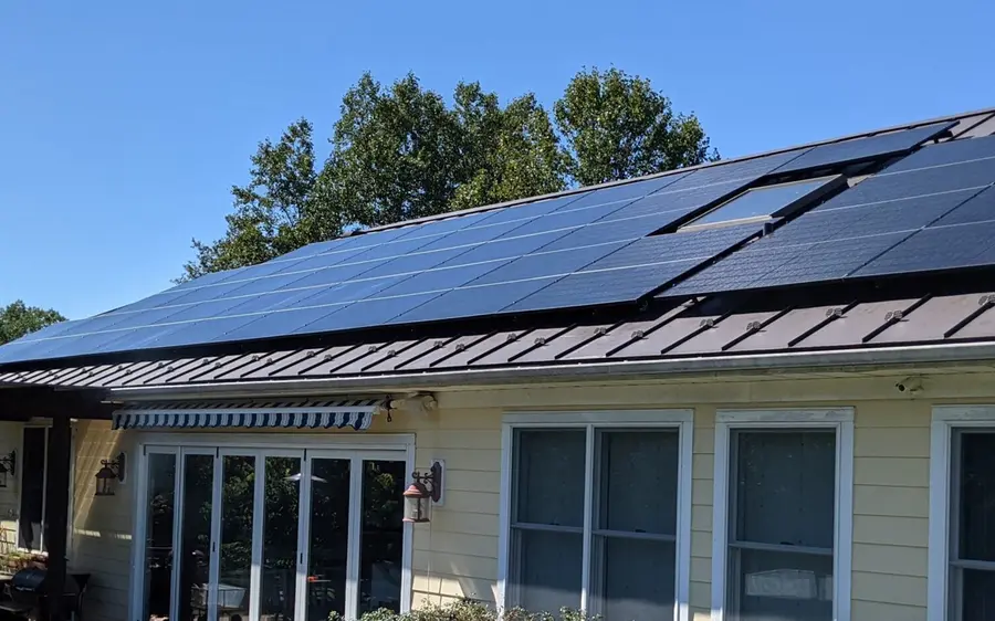 All black solar electric modules on the standing seam metal roof of a Florida home, installed by Demo Solar Company.